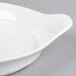 A close-up of a Libbey white porcelain handled dish.
