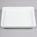 A white square porcelain tray with a small rim.