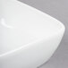 A close up of a Libbey Aluma White Porcelain square bowl.