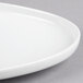 A white Libbey aluma white porcelain oval tray with a curved edge.