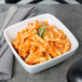A Libbey Chef's Selection square bowl filled with pasta and tomato sauce.
