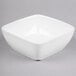 A Libbey white square bowl on a gray surface.