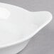 A Libbey white porcelain handled dish on a gray surface.