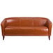 A Flash Furniture brown leather sofa with wooden legs.