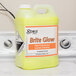A yellow bottle of Noble Chemical Brite Glow laundry emulsion on a counter.