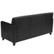 A Flash Furniture black leather sofa with wooden legs.