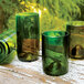 Three Arcoroc green wine bottle tumblers on a table.