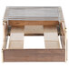 A wooden box with metal bars that holds a Cal-Mil Mid-Century Walnut Butane Range Frame with brass accents.