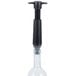 A Vacu Vin wine saver vacuum pump with a black handle and two glass stoppers.