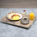 A Cal-Mil hickory melamine room service tray with breakfast food and drink on it on a table.