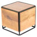 A wooden cube with black metal legs.