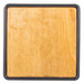 A wood square with black frame on it.