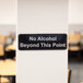 A black and white Tablecraft sign that says "No Alcohol Beyond This Point"