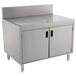 An Advance Tabco stainless steel drainboard cabinet with doors and a shelf over a stainless steel sink.