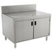A stainless steel Advance Tabco drainboard cabinet with doors and a shelf over a sink.