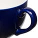 A close up of a blue Tuxton cappuccino cup with a handle.