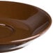 A brown saucer with a small edge.