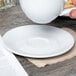 Tuxton BPE-0631 6 3/8" Porcelain White Cappuccino China Saucer - 24/Case Main Thumbnail 1