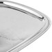 A Vollrath stainless steel oblong serving tray with a floral design.