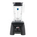 A Waring commercial blender with a clear container and black base.