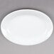 A Tuxton Alaska white oval china platter with a wide white rim.