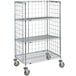 A Metro Super Erecta chrome wire slanted shelf cart with three tiers and wheels.