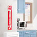 A red and white Buckeye fire extinguisher adhesive label on a wall above a fire extinguisher.