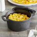An American Metalcraft pre-seasoned cast iron pot with macaroni and cheese inside.