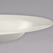 A white Carlisle melamine bowl with a rim.