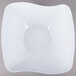 A white melamine square bowl with a wavy edge.