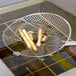 A Thunder Group round mesh skimmer with french fries frying in oil.