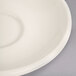 A white narrow rim saucer on a white surface.