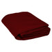 A stack of folded burgundy round polyester table covers.