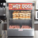 A Mr. Frank hot dog steamer with hot dogs in it.