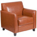 A Flash Furniture Hercules Diplomat cognac leather chair with wooden legs.