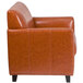 A Flash Furniture Hercules Diplomat Cognac leather chair with wooden feet.