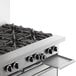 A stainless steel Garland commercial gas range with eight burners, a standard oven, and a storage base.