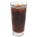 A Libbey stackable cooler glass filled with cola and ice with a straw.