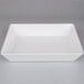 A white rectangular American Metalcraft melamine serving bowl on a gray surface.