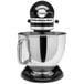 A KitchenAid Artisan Series countertop mixer in black and silver with a black bowl.