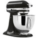 A black and silver KitchenAid Artisan stand mixer with a white background.