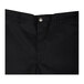 A close up of Chef Revival black chef trousers with buttons on the side.