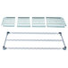 A grey metal MetroMax Q shelf with a white plastic grate with holes.