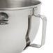 A KitchenAid polished stainless steel mixing bowl with a handle.