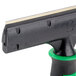 A close-up of a black and green Unger ErgoTec Glass Scraper handle.