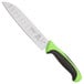 A white knife with a green handle.