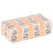 A white and orange rectangular candy box with designs on it.