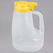 A Tablecraft clear plastic jug with a yellow lid.