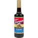 A Torani Coffee Flavoring Syrup 750 mL glass bottle with a red label.