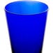 A blue glass tumbler on a white background.